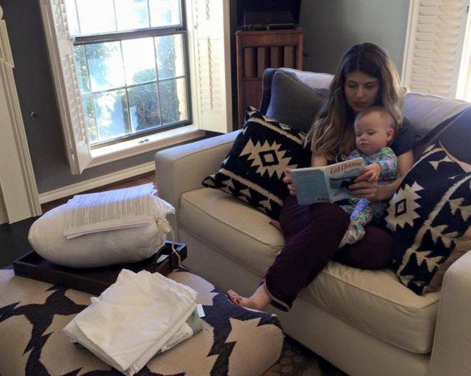 Hannah with her daughter Lorelai teaching her through a book.