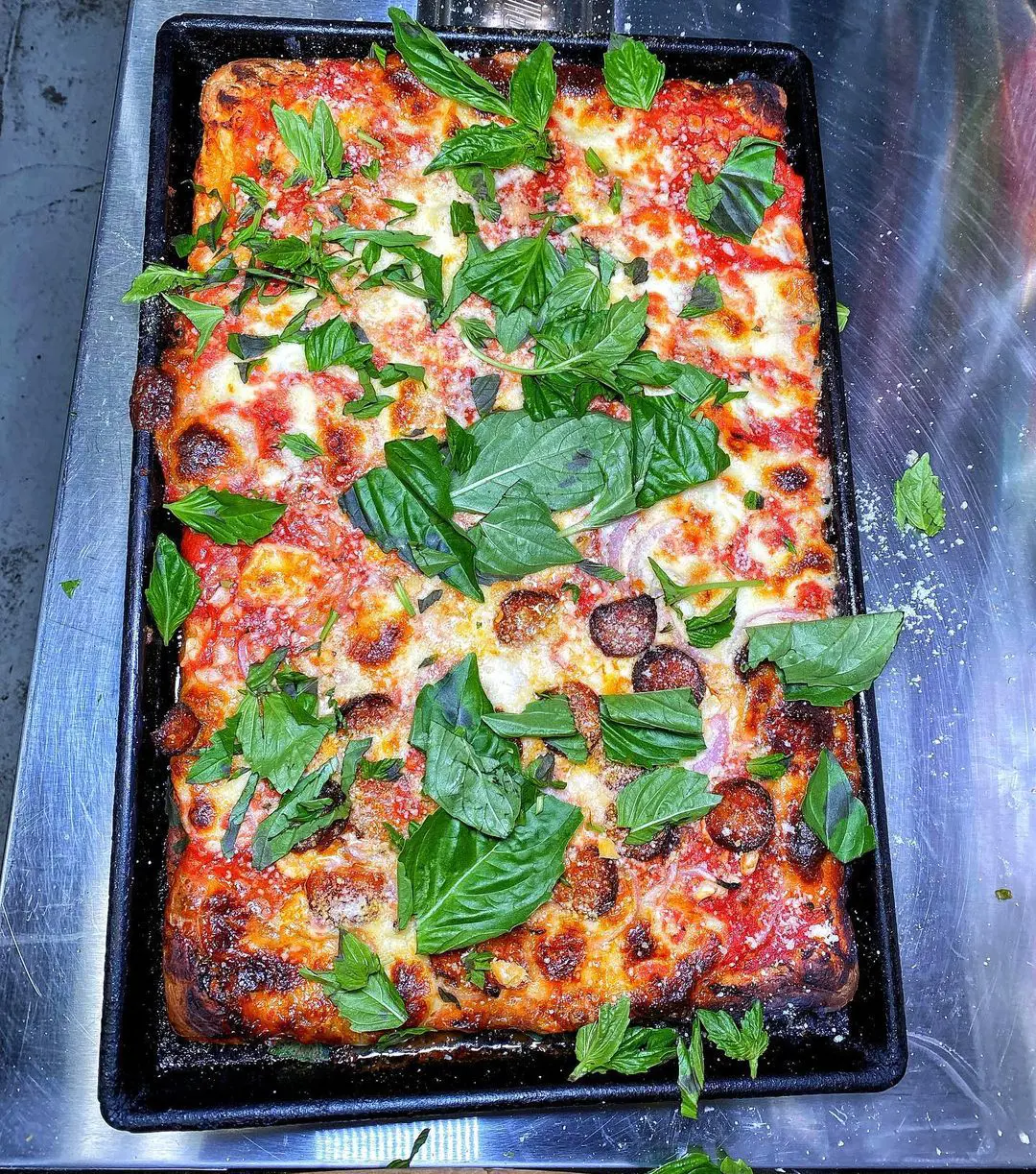 A square pie garnished with herbs from Di Fara Pizza photographed by @mikenyc10